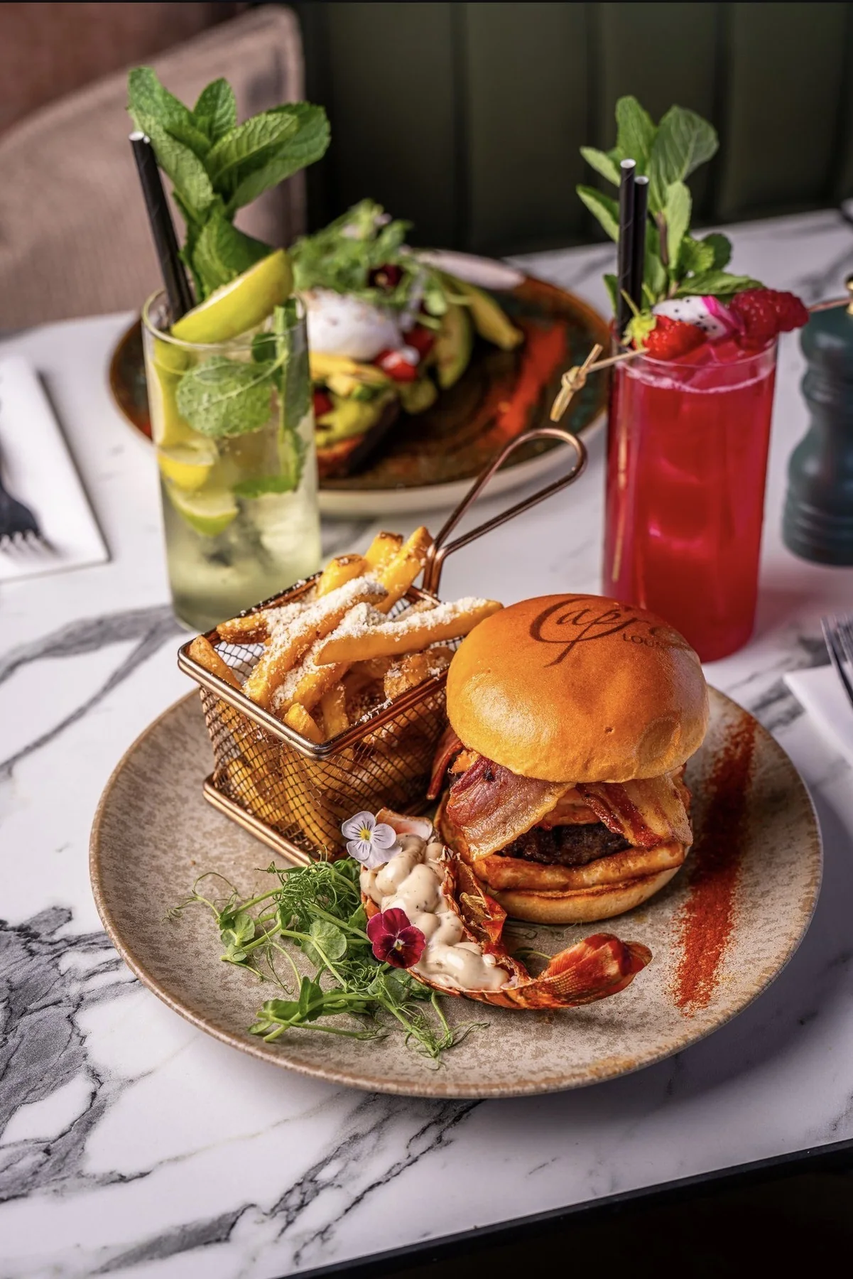 Burger, fries and colourful drinks at Cafe Capri Lounge